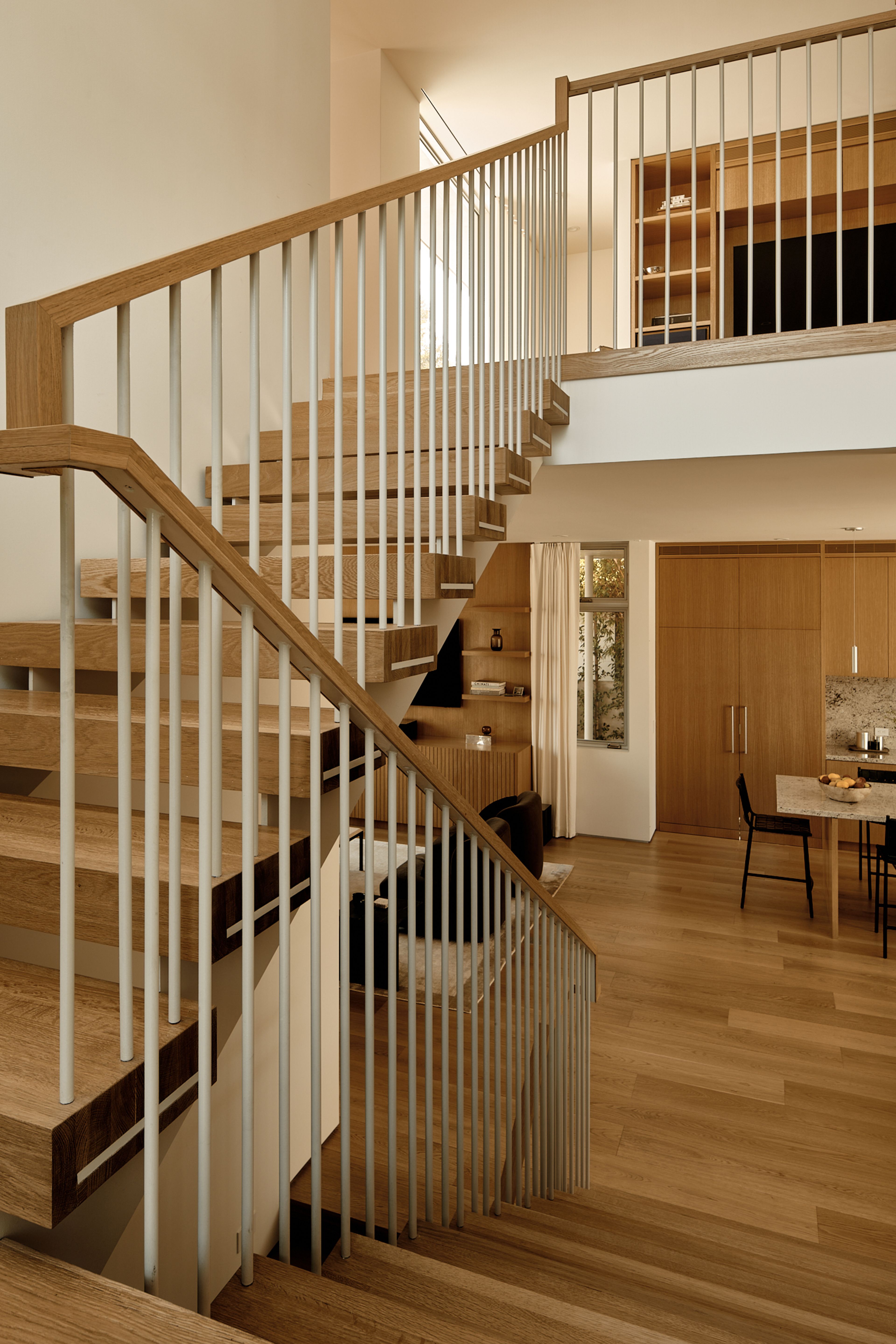 A guardrail made of a combination of custom painted steel and white oak