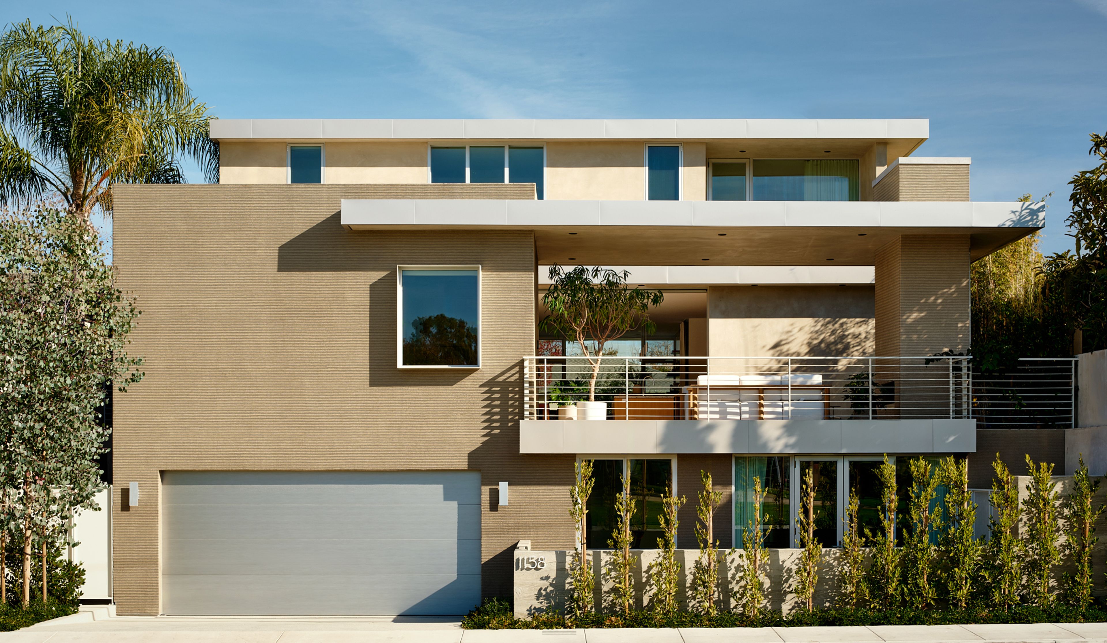 From the rear, the house is actually three stories. A lower level ADU has its own courtyard