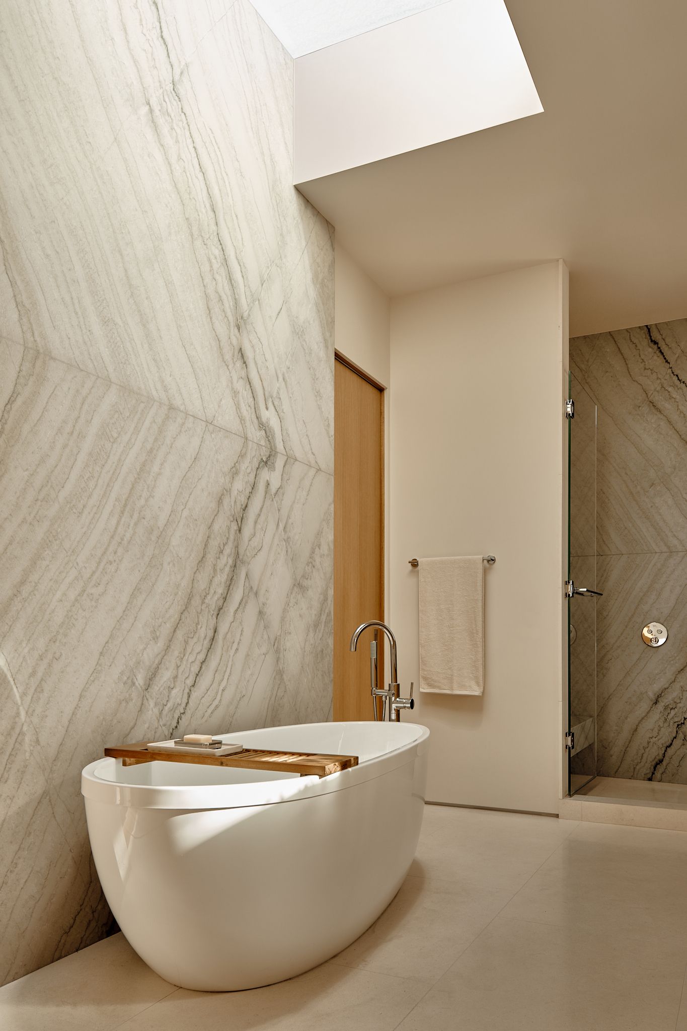 A large skylight brings natural light into the Primary Bathroom