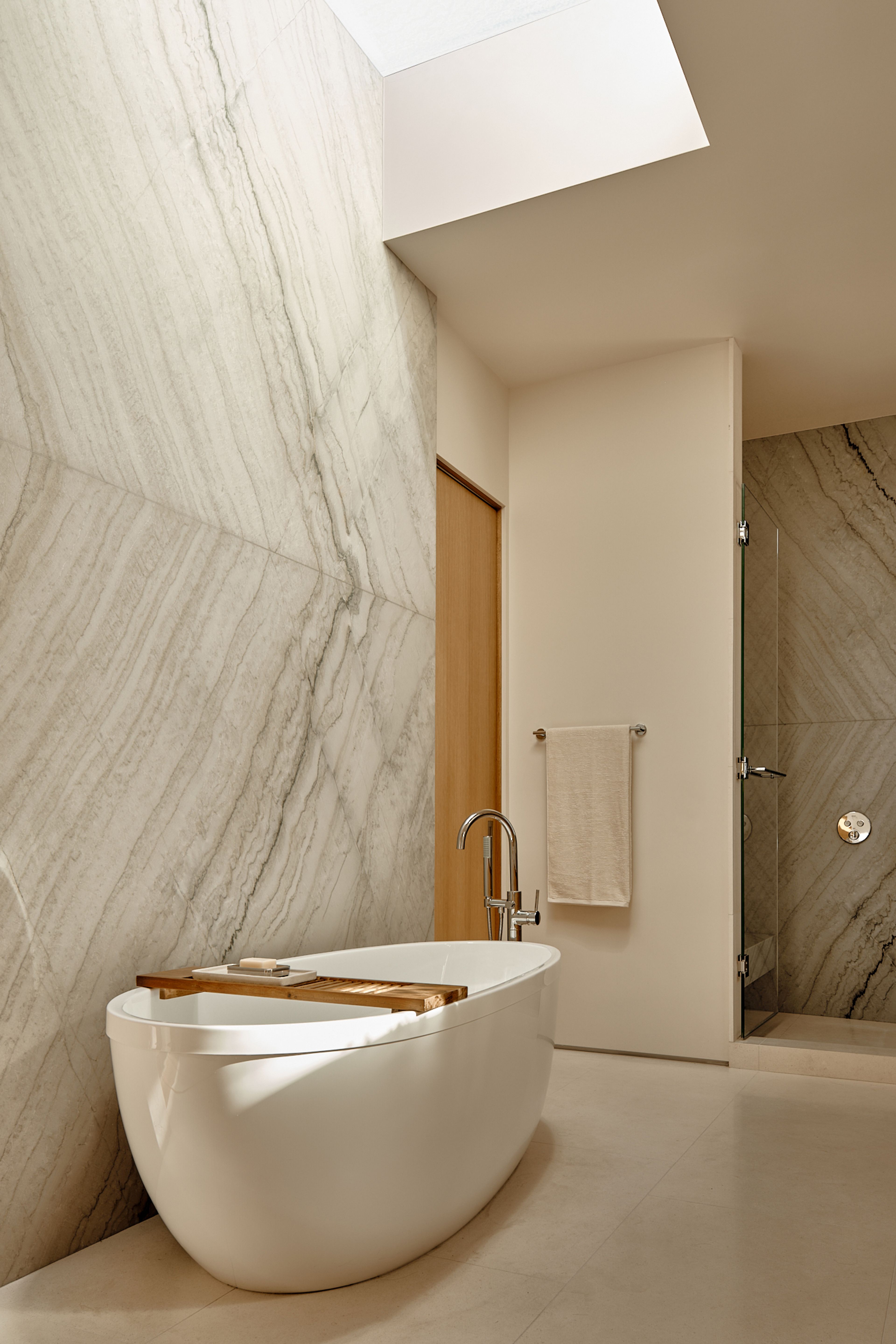 A large skylight brings natural light into the Primary Bathroom