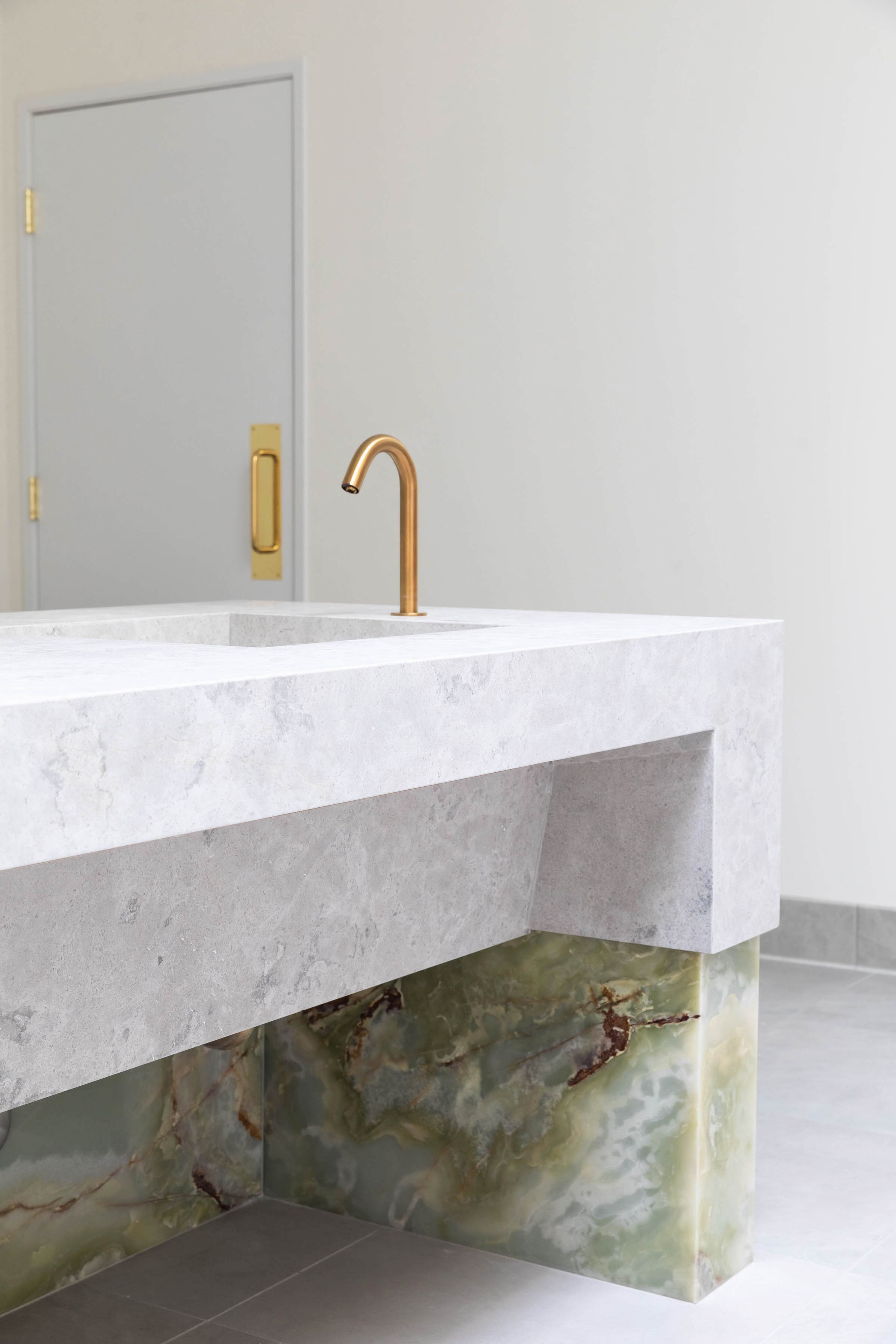 Onyx, brass & limestone details.