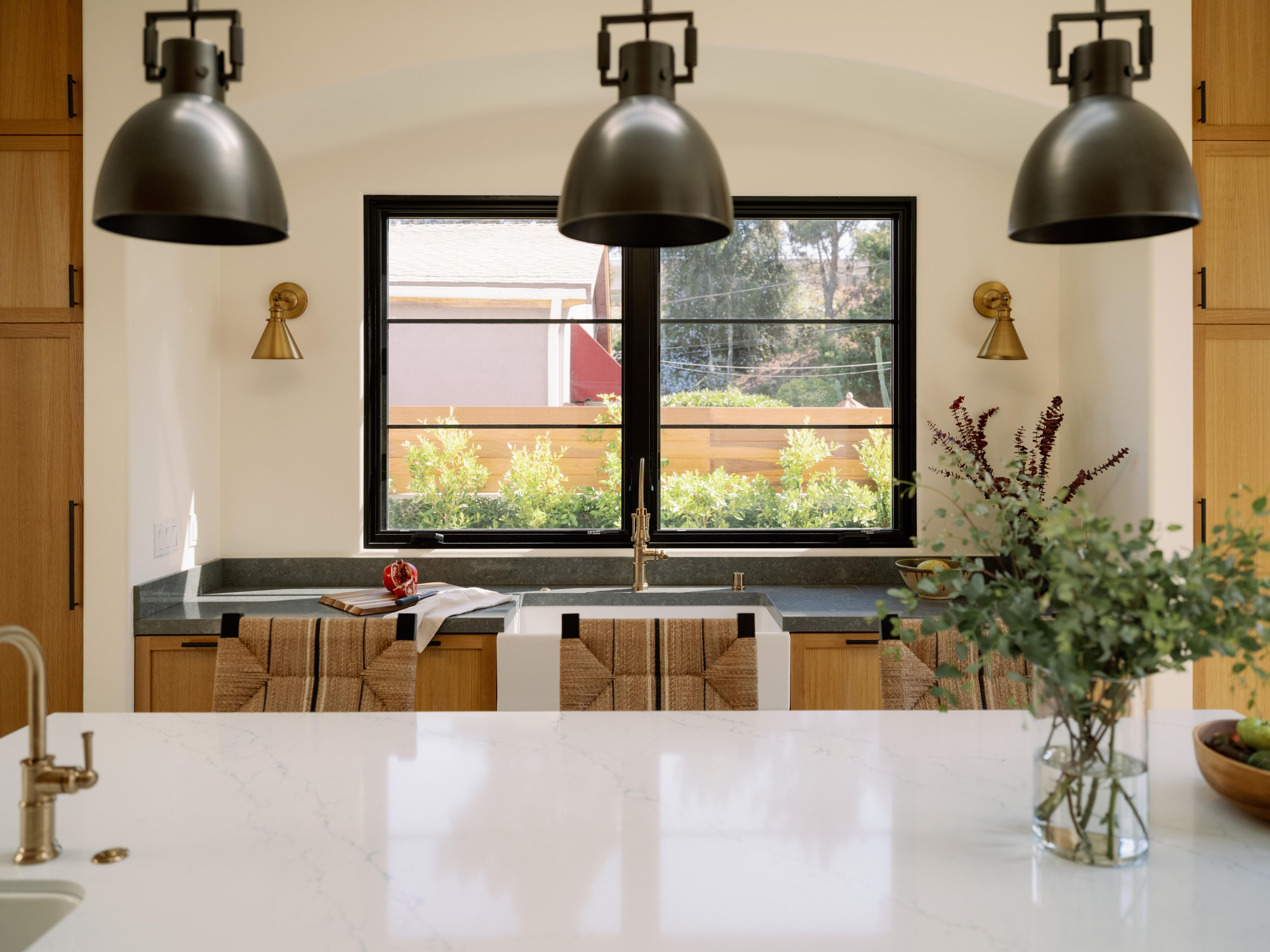 An arched opening frames the sink and large window