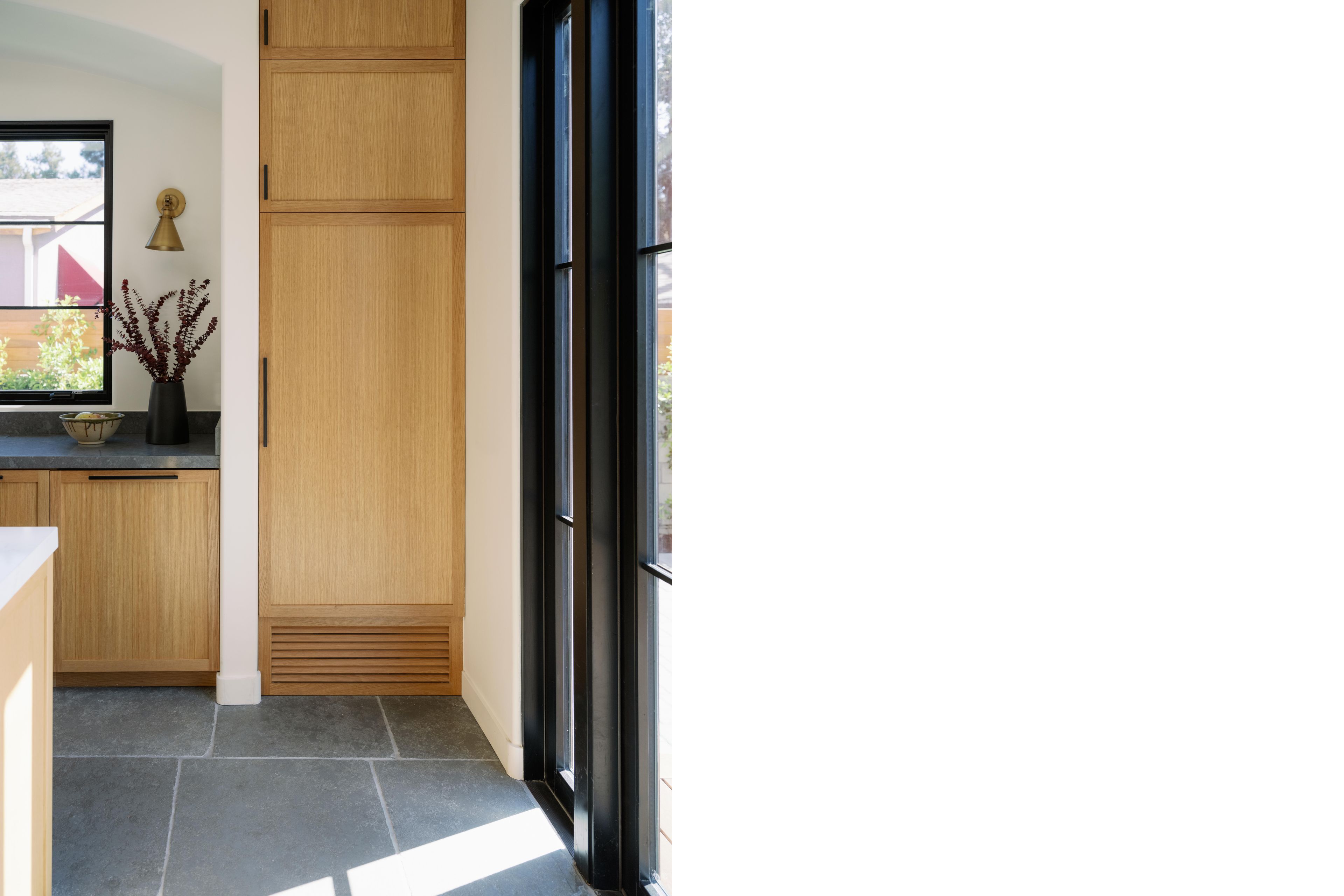 Custom AC supply grilles were integrated into the white oak cabinetry