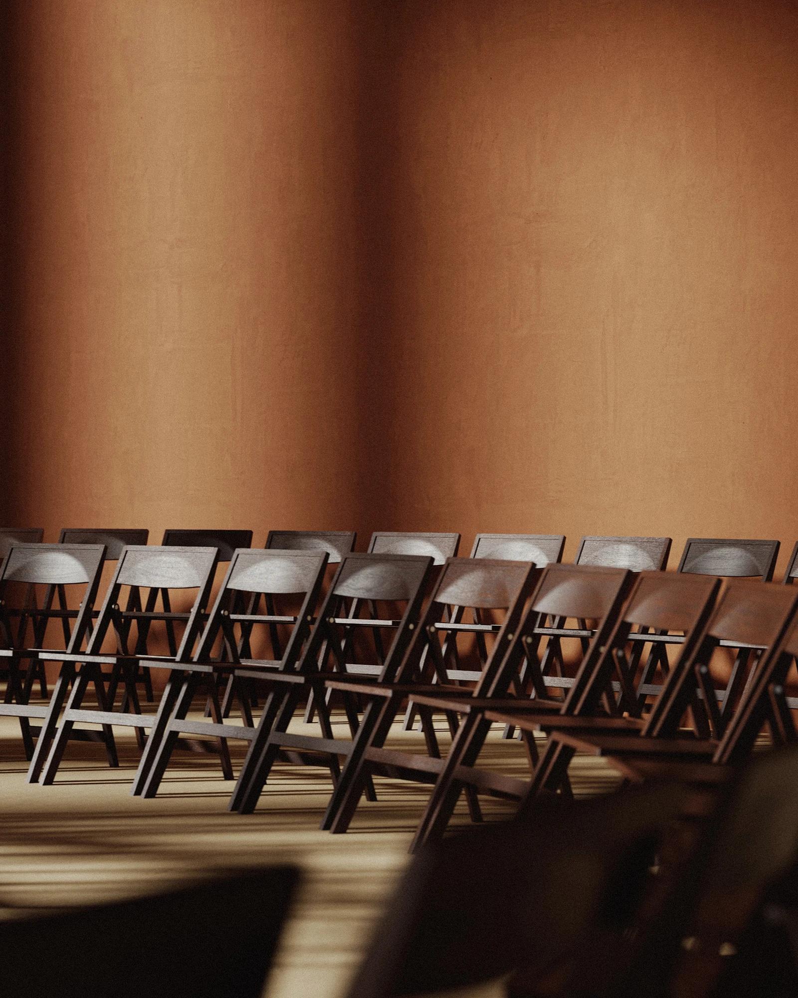 Dark brown Frama folding chair in a circular row