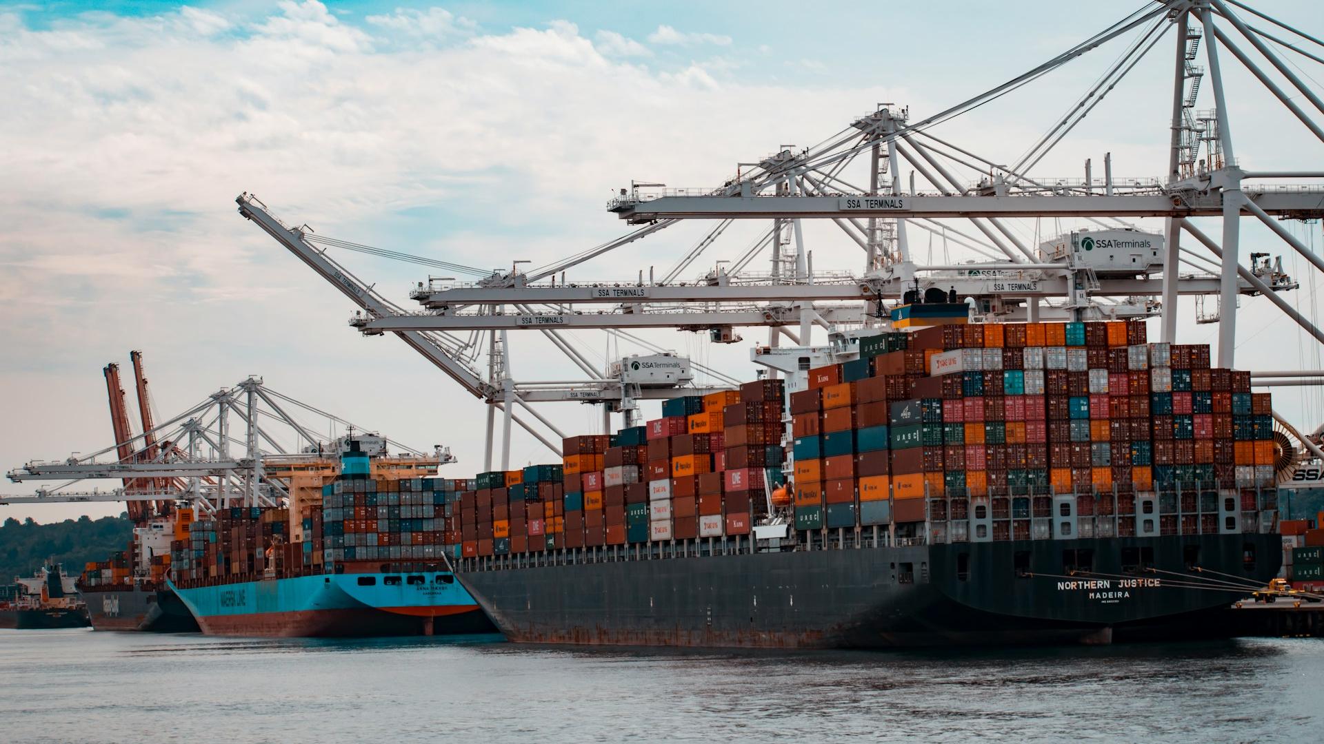 Bulk carriers loading iron ore at a Guinean export terminal, symbolizing the rapid growth of Guinea’s mining exports and international trade activity.