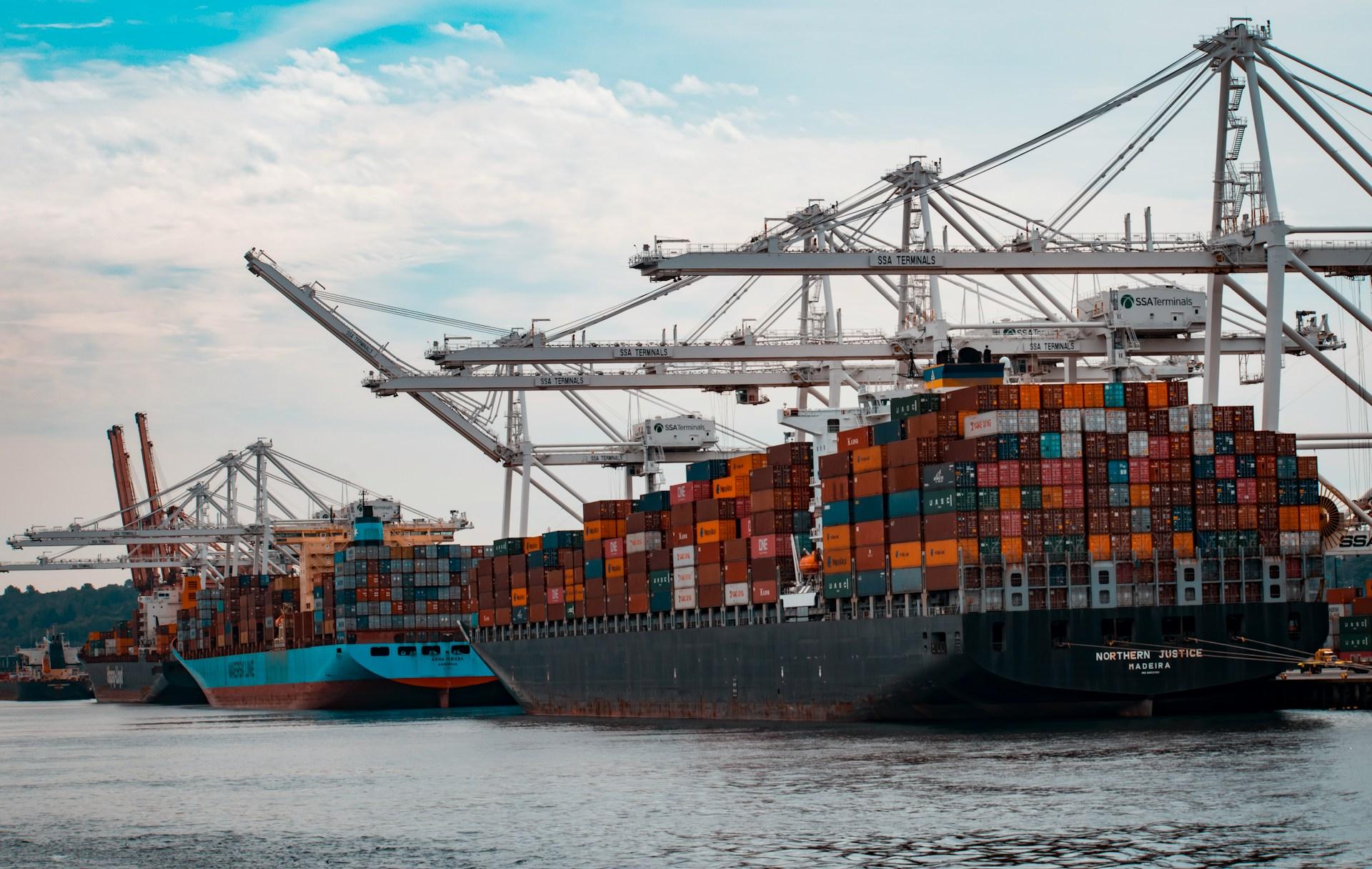 Bulk carriers loading iron ore at a Guinean export terminal, symbolizing the rapid growth of Guinea’s mining exports and international trade activity.
