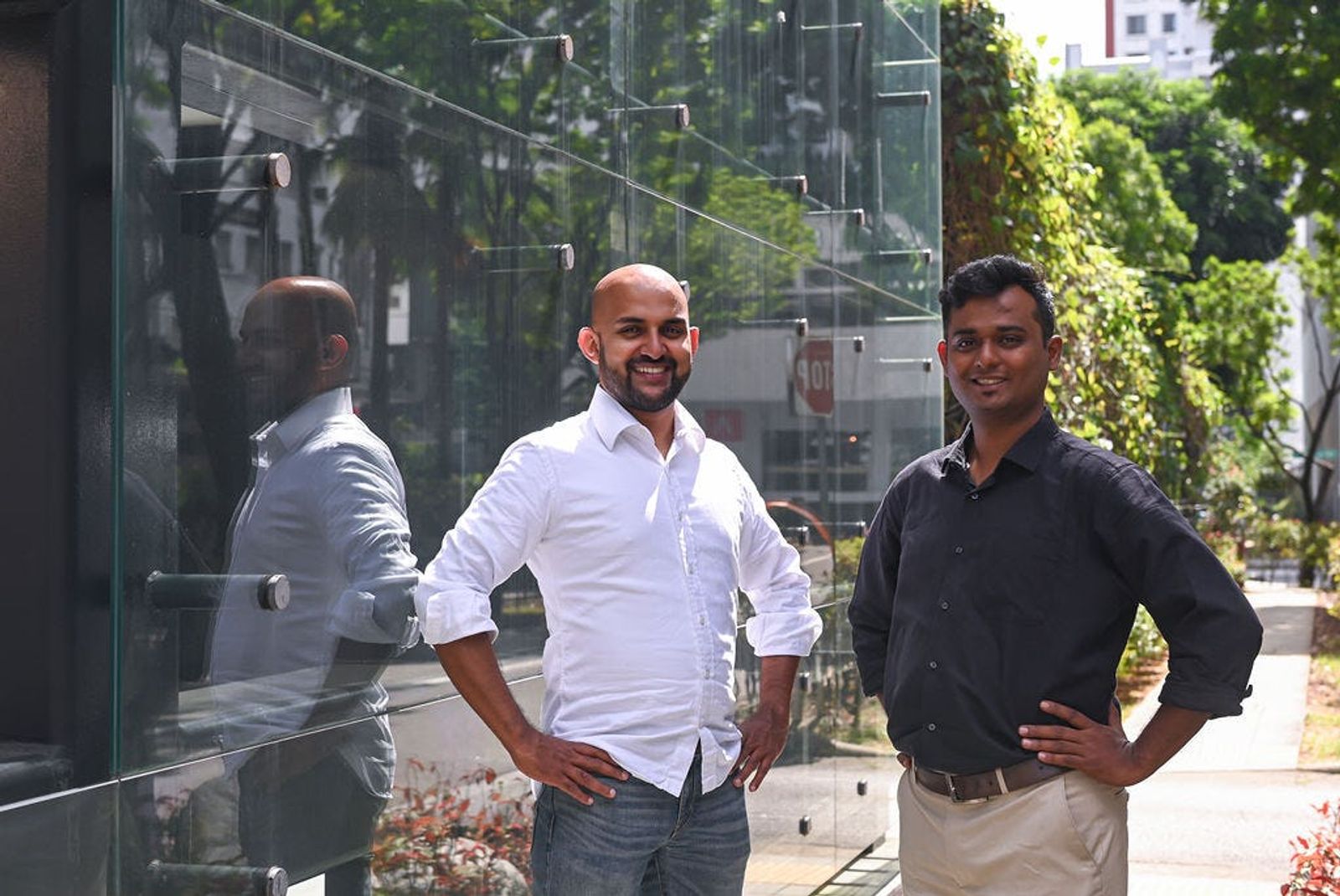 Goblin CEO Jim Nadackal and CTO Phaneendra Chiruvella pose with hands on hips outside building