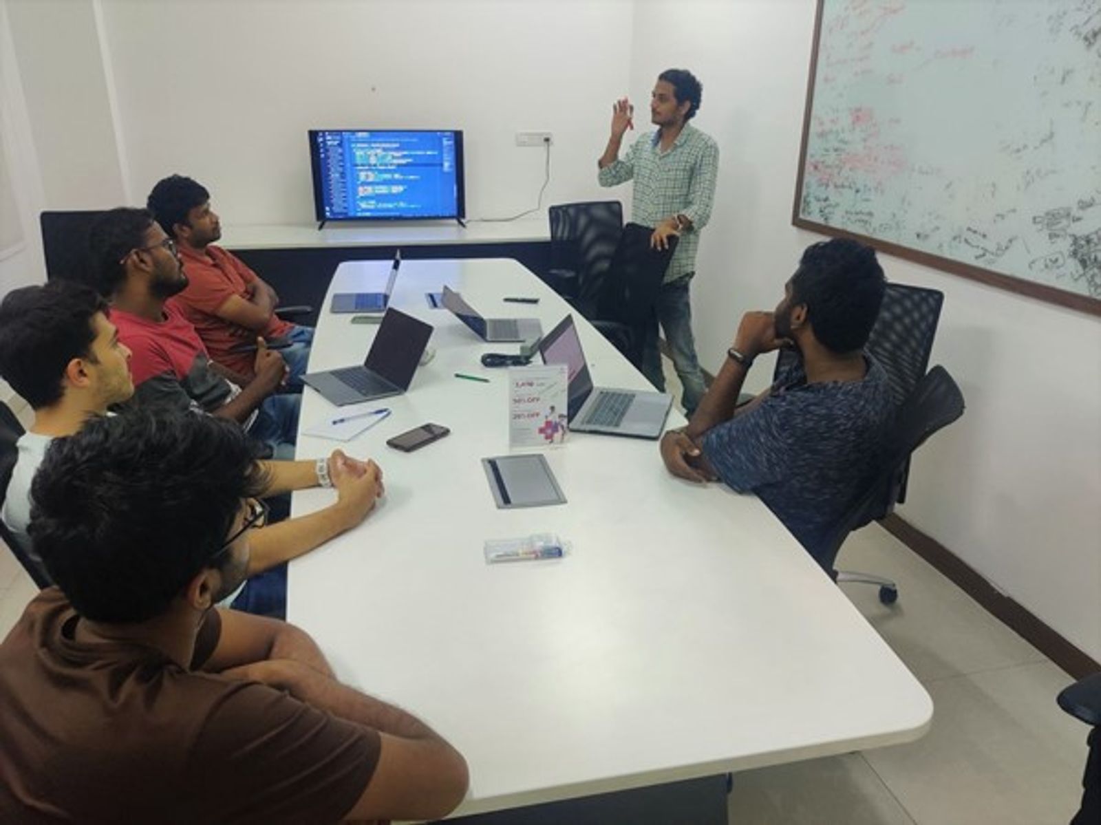 An image of a meeting featuring Raijith Shaji, co-founder and CEO of Volopay and his team during a team meeting