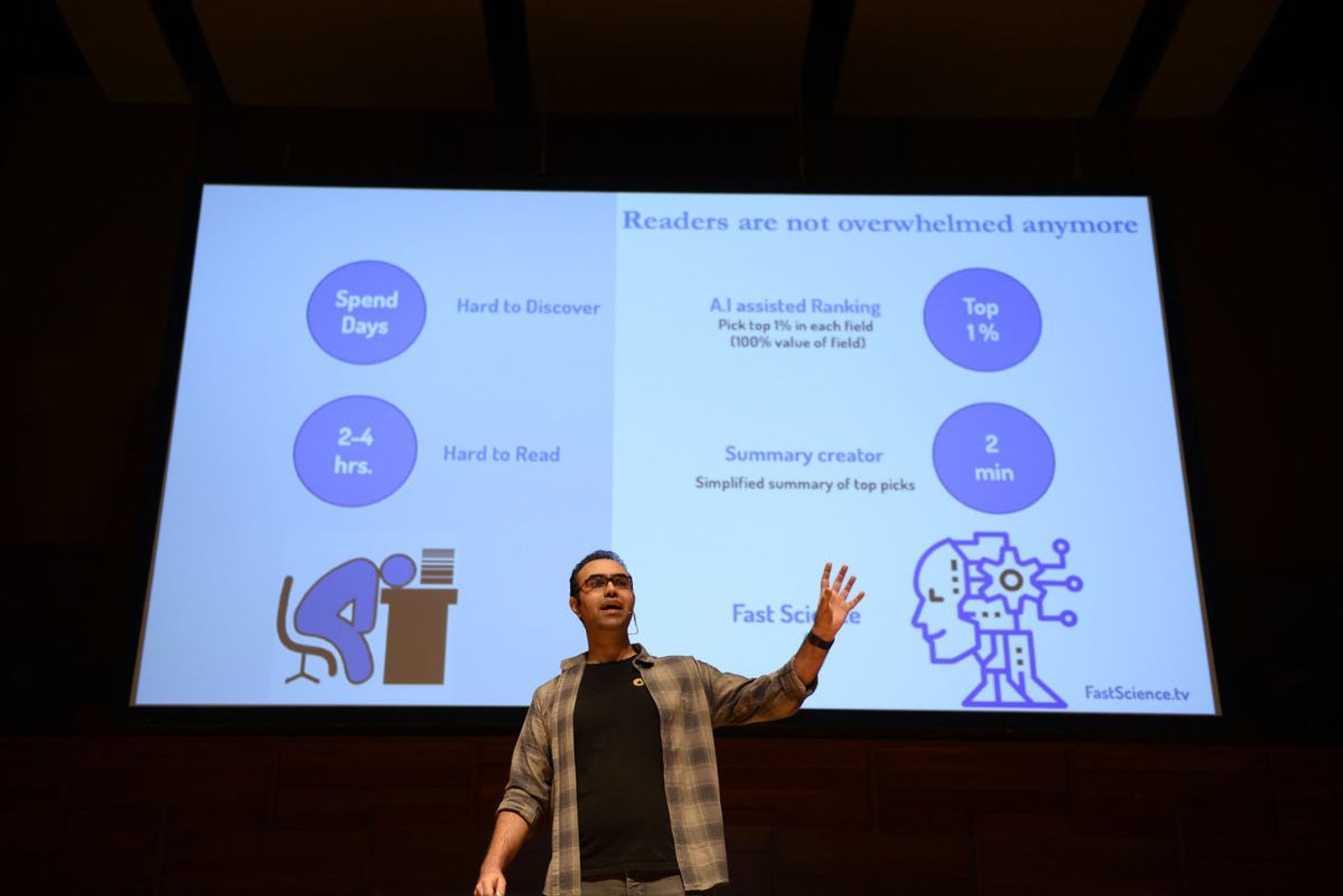 Fast Science representative presenting on stage at Singapore Demo Day with presentation in the background
