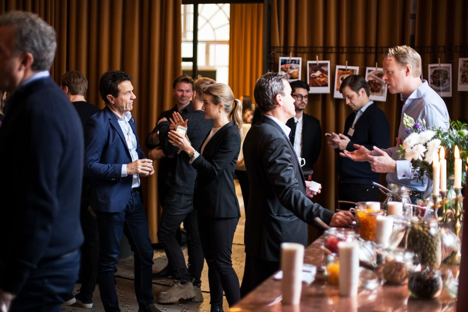 Individuals having discussions in pairs and small groups at demo day