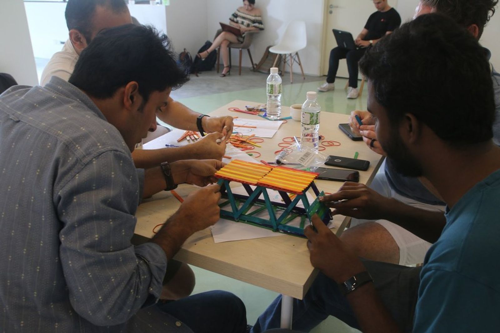 An image of Antler Demo day founders participating in a bridge building group exercise