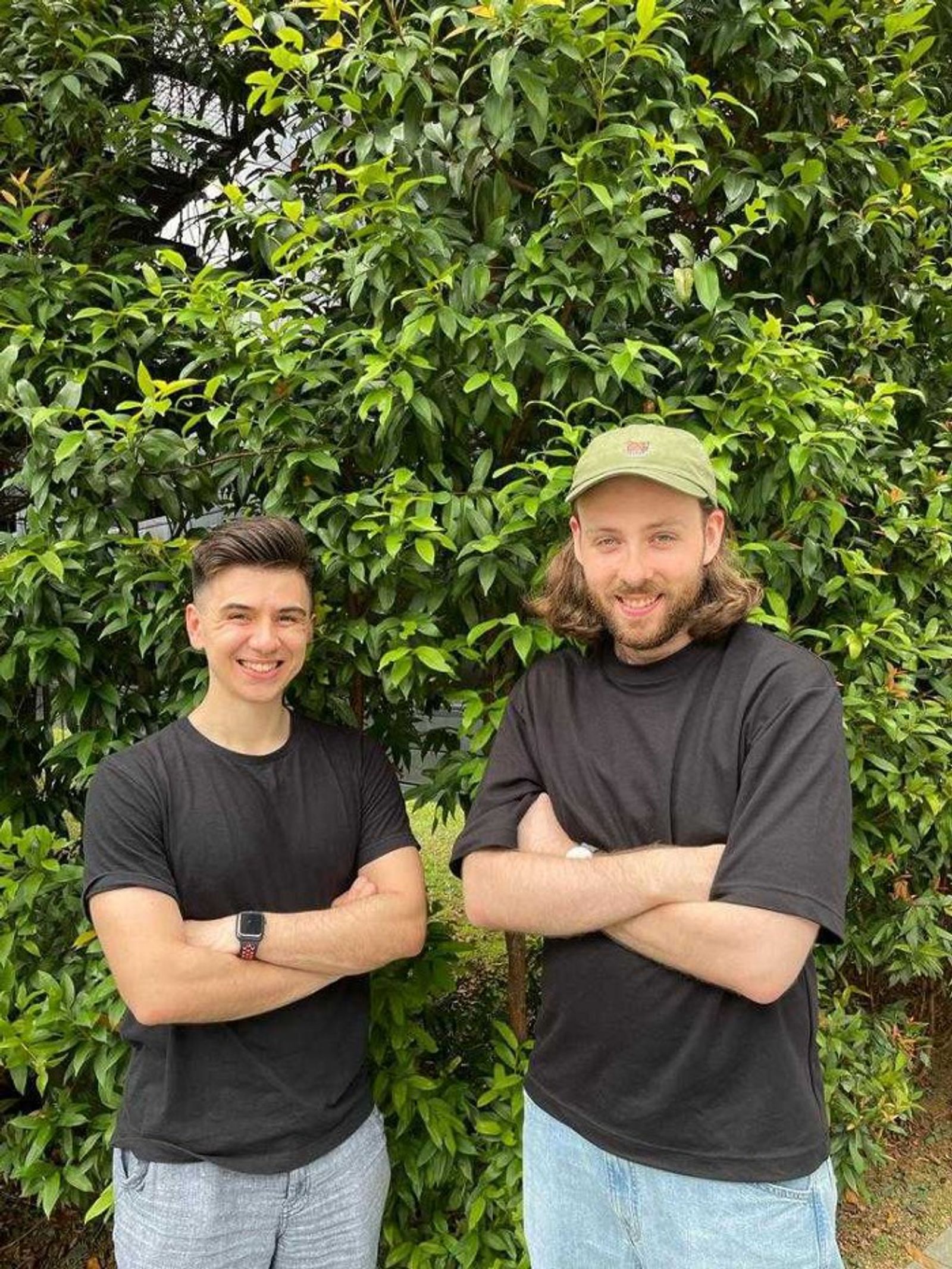 An image of Faba co-founders Alex & Sean standing outside in front of a blossoming tree