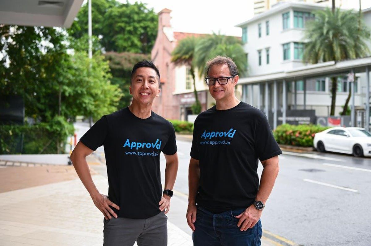 Photo of Approvd CEO James Teo and COO Adam Hobson wearing black Approvd t shirts outside