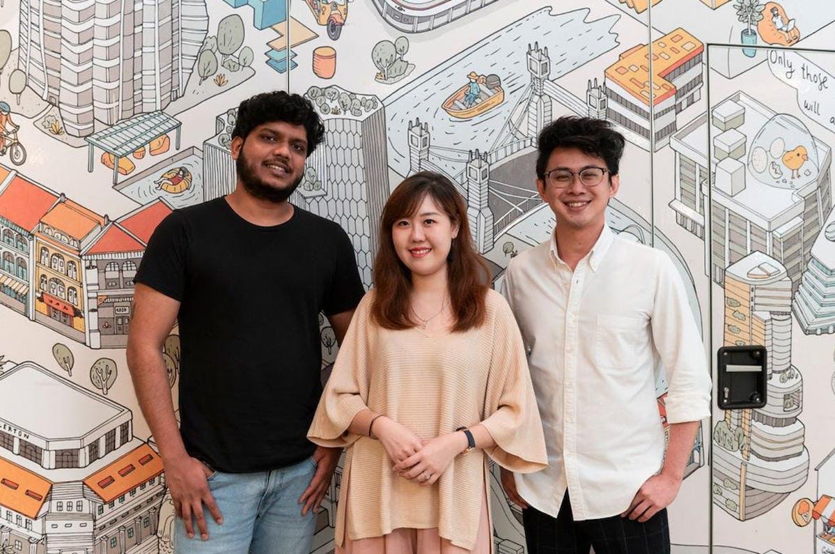 Photo of Pawjourr CTO Navaneeth Sreekanth, CMO Jane Peh and CEO Tay Sijun in front of mural