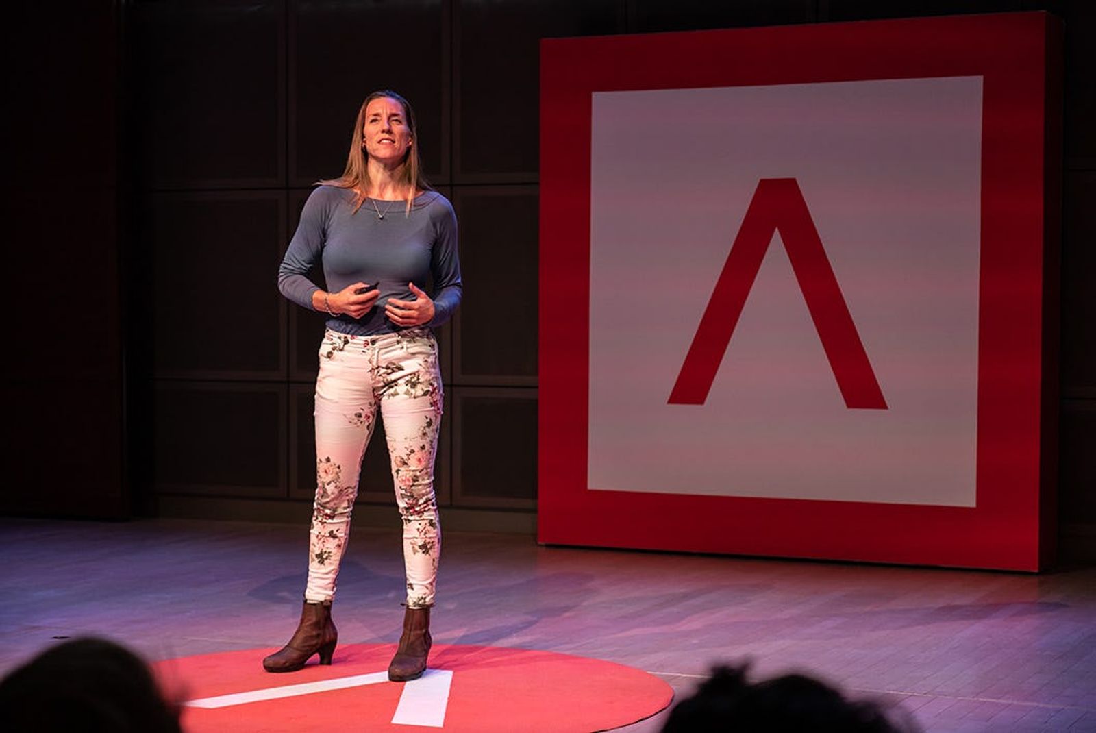 RespiQ co-founder and CEO Mira Gleisberg presenting on stage with Antler Logo in the background 