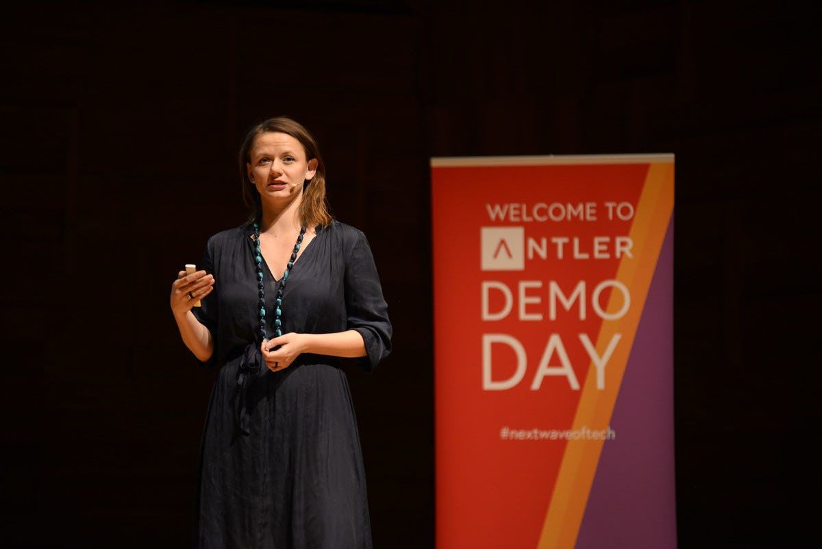Soma Sketch representative presenting on stage at Singapore Demo Day with Antler sign in the background