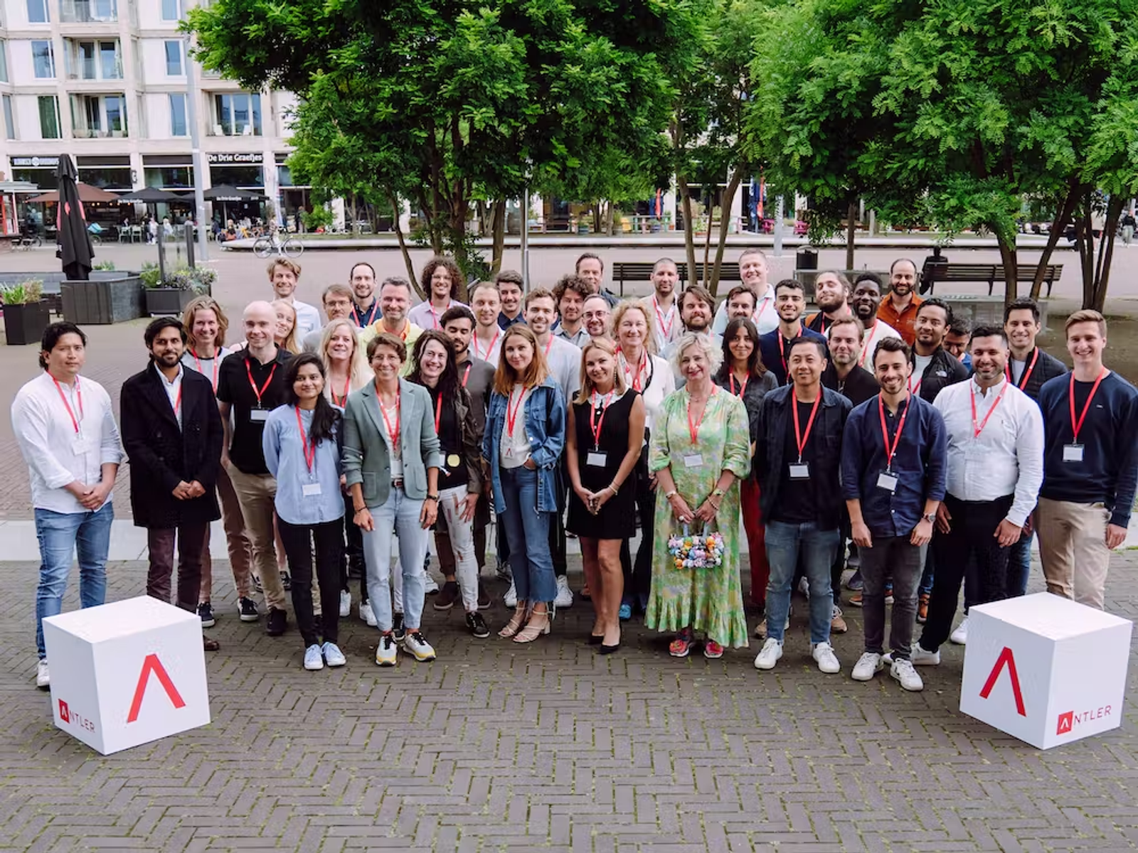 Group wearing lanyards take a photo with Antler logo cubes in Amsterdam 