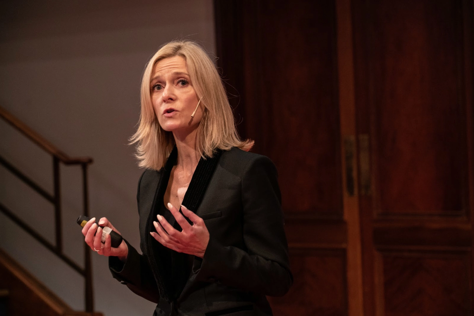 Image of Beatrice Zatorska wearing black in the midst of making a presentation 