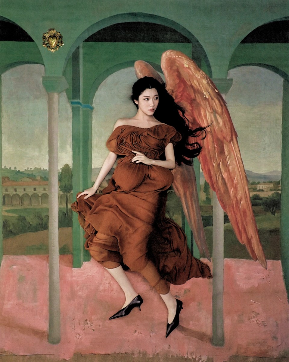 Sammi Chen in a rust dress with painted wings beneath green arches.