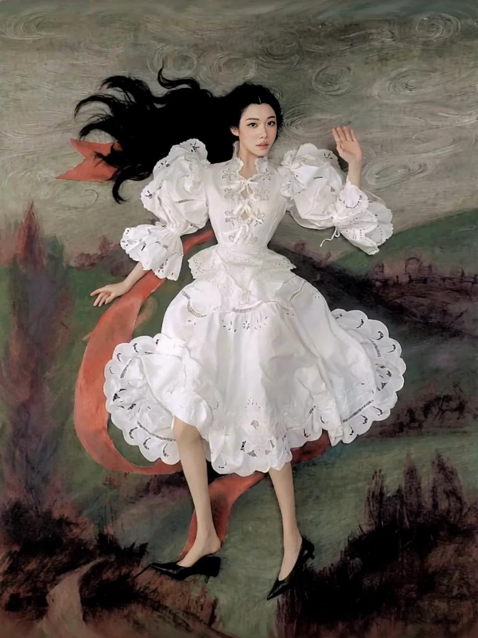 Sammi Chen in a white ruffled dress reclining in a painted landscape.