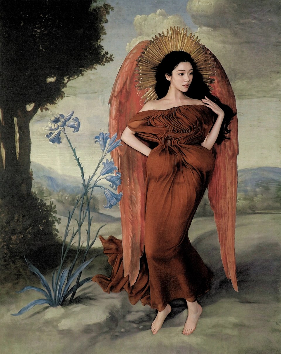 Sammi Chen in a rust dress with painted wings in a theatrical landscape.