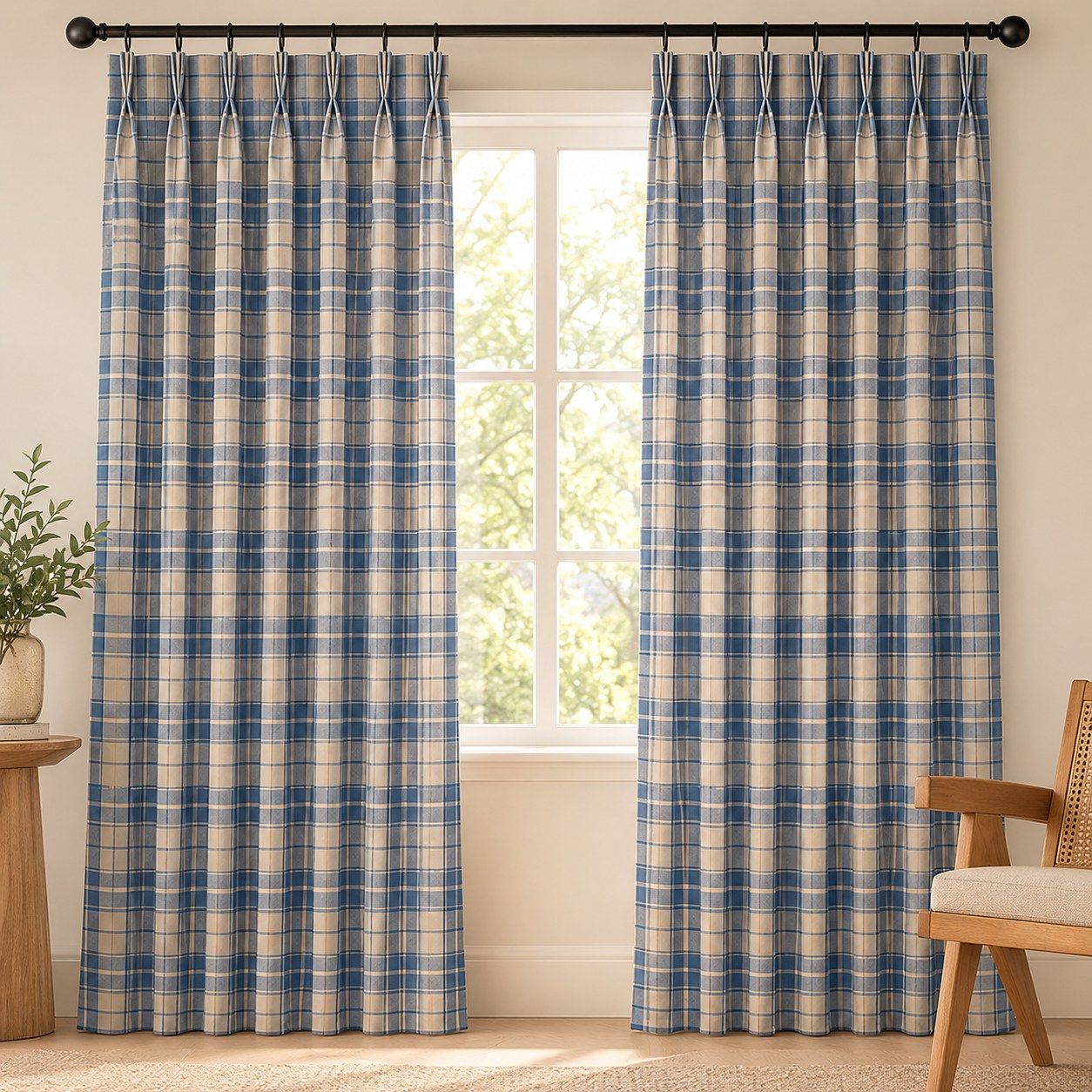 Blue gingham pinch pleat curtains hanging at a bright window