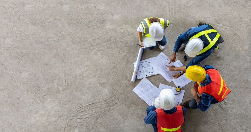 Construction team taking a close look at construction plans.