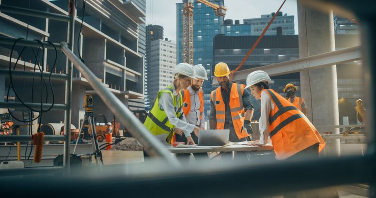 A team of construction workers looking at plans who benefit from accounting and bookkeeping services provided by kept.pro, emphasizing efficiency and financial management.