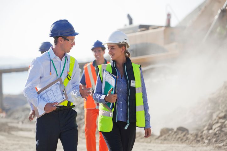 Construction project managers walking a job site.