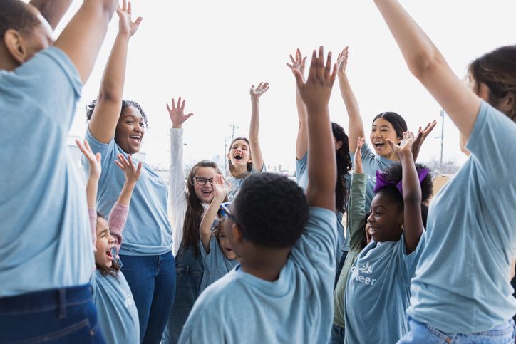 a group of young adults working with kids