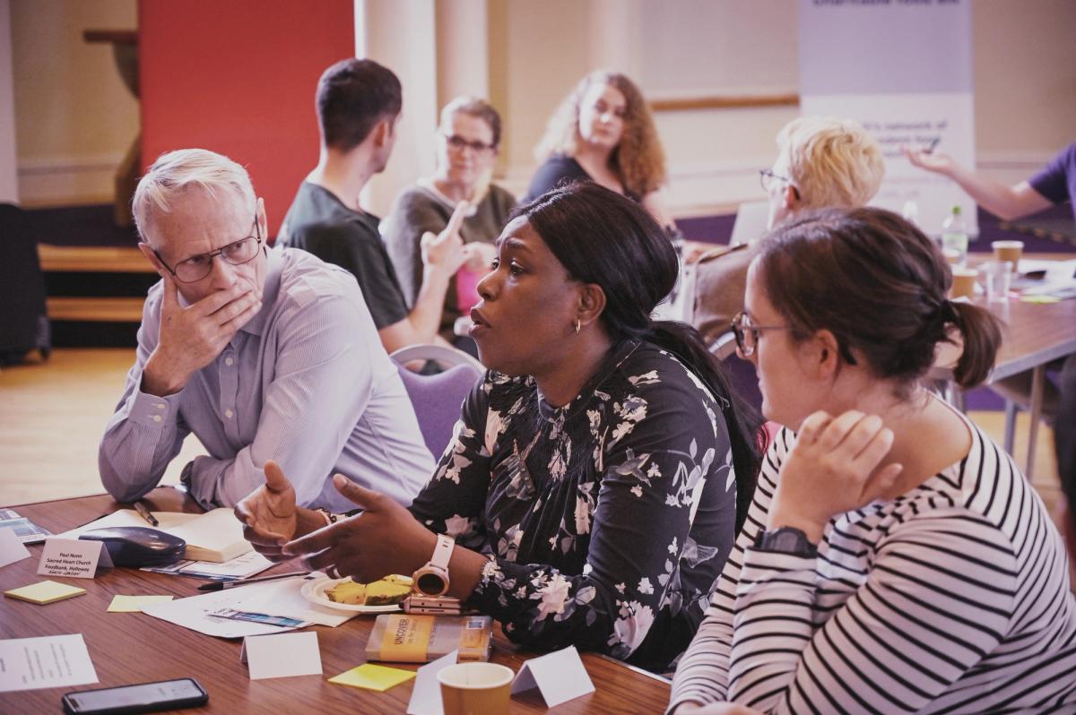 Members discussing policy at event
