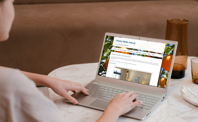 Woman looking at the direct booking website for Osprey House Orlando on her laptop