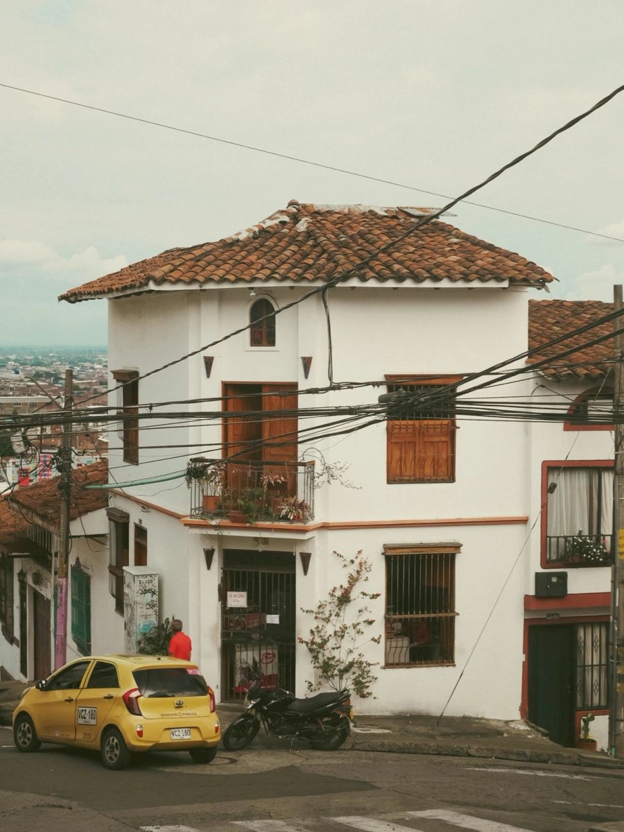 White colonial house with red roof