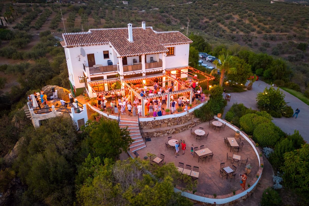 Aerial view of an evening event on the lantern-lit terrace