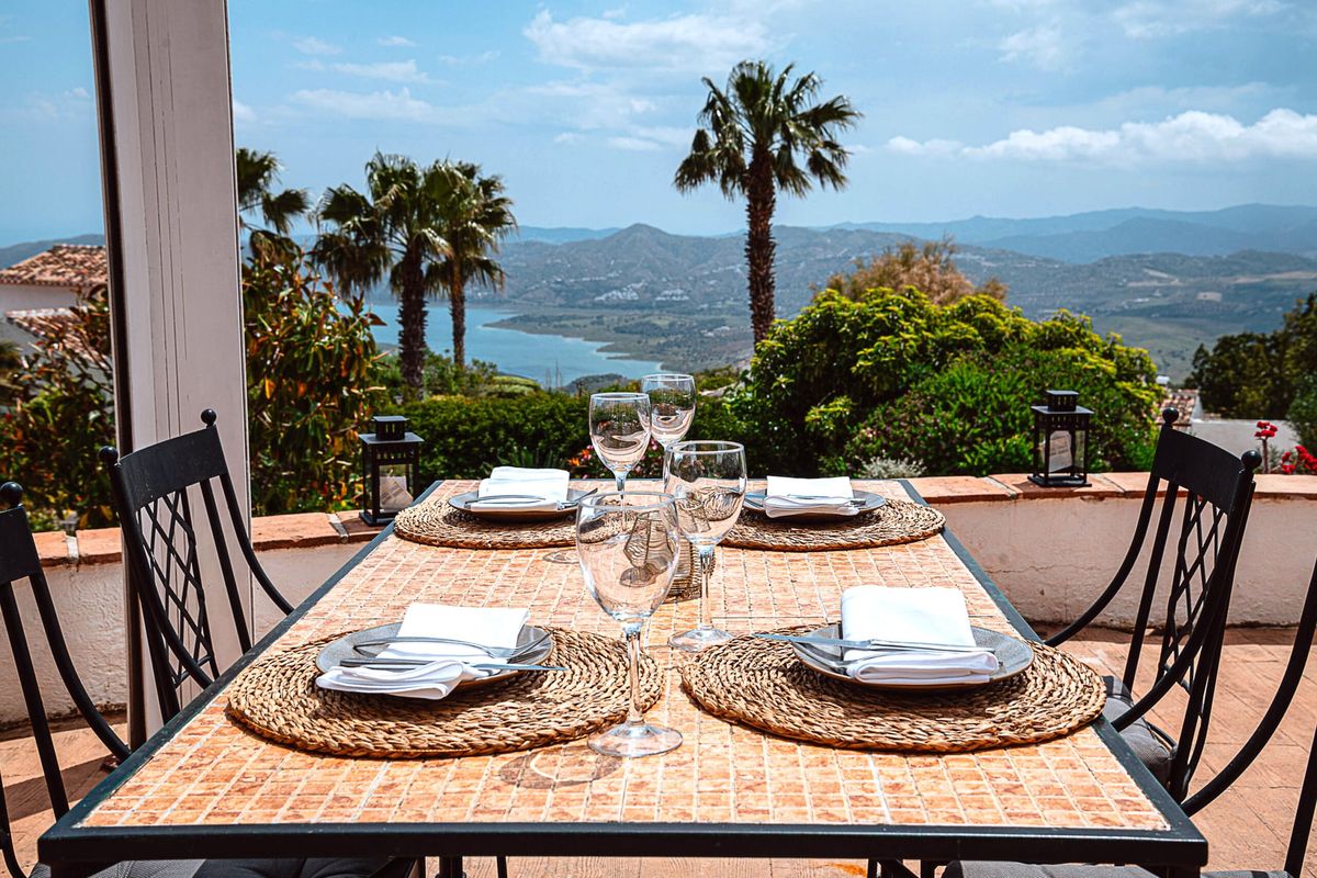 Table laid for lunch on the terrace with views over Lake Viñuela