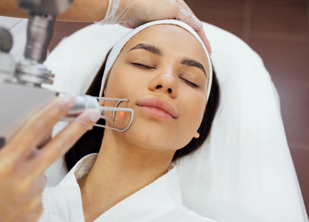 woman being treated with a laser on her face