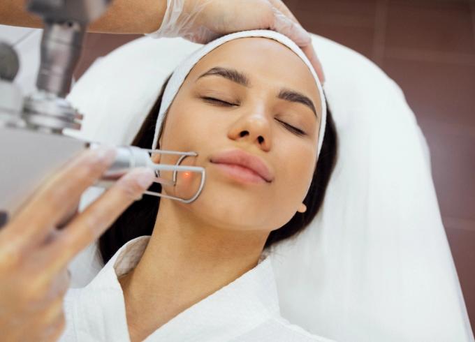 woman receiving laser treatment on her face