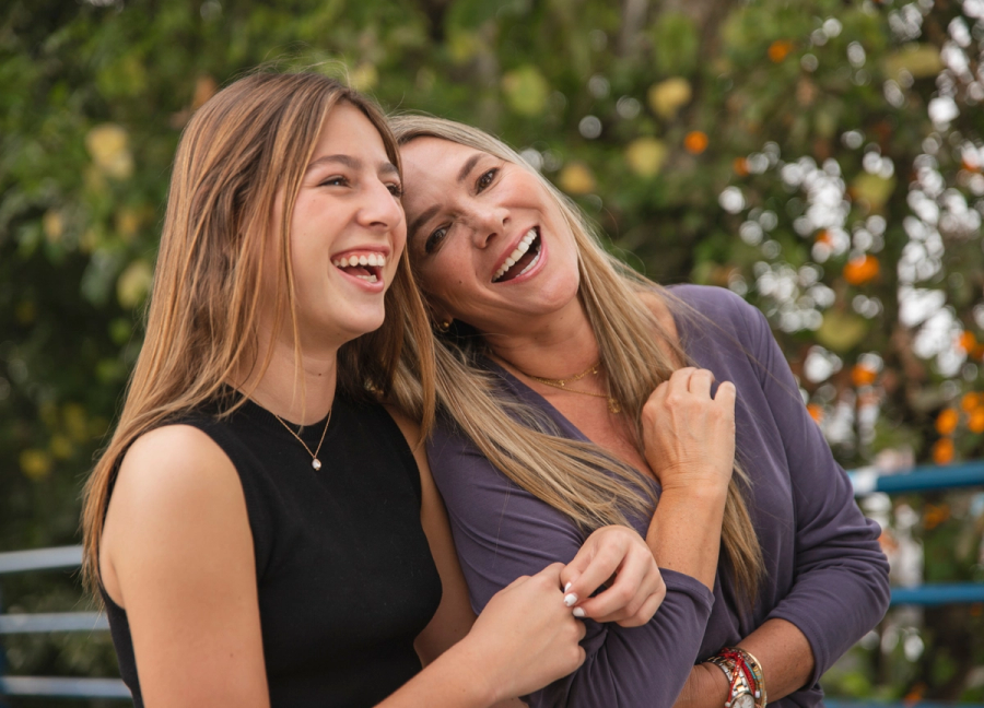 mom and daughter laughing outside