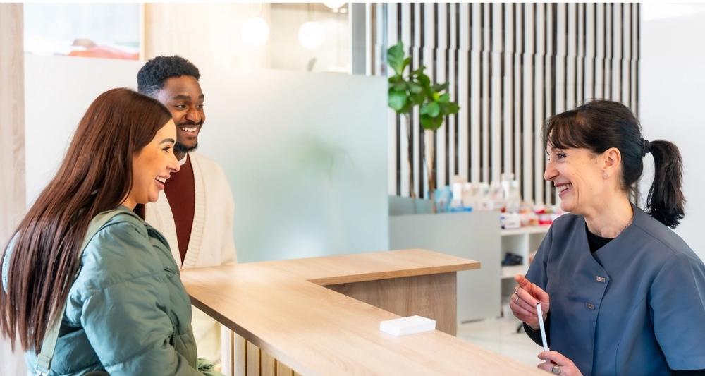 people at a front desk of a medspa having a pleasant interaction