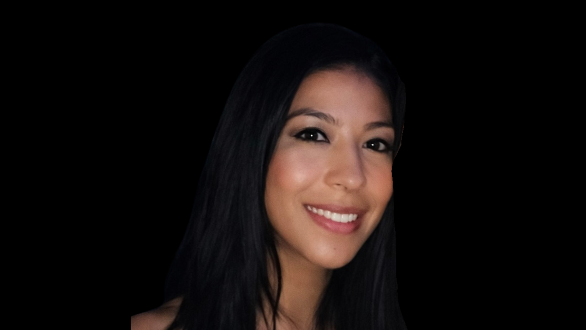A picture of a young brunette woman looking at the camera, she is smiling. The background is black.