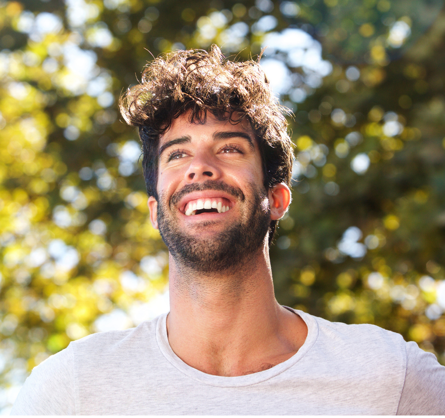 man smiling in the outdoors