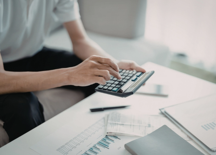 man making calculations on a calculator