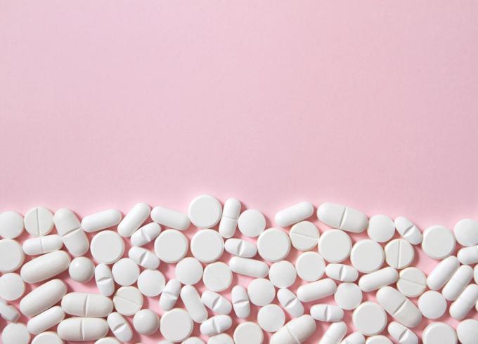 Pills on a pink surface