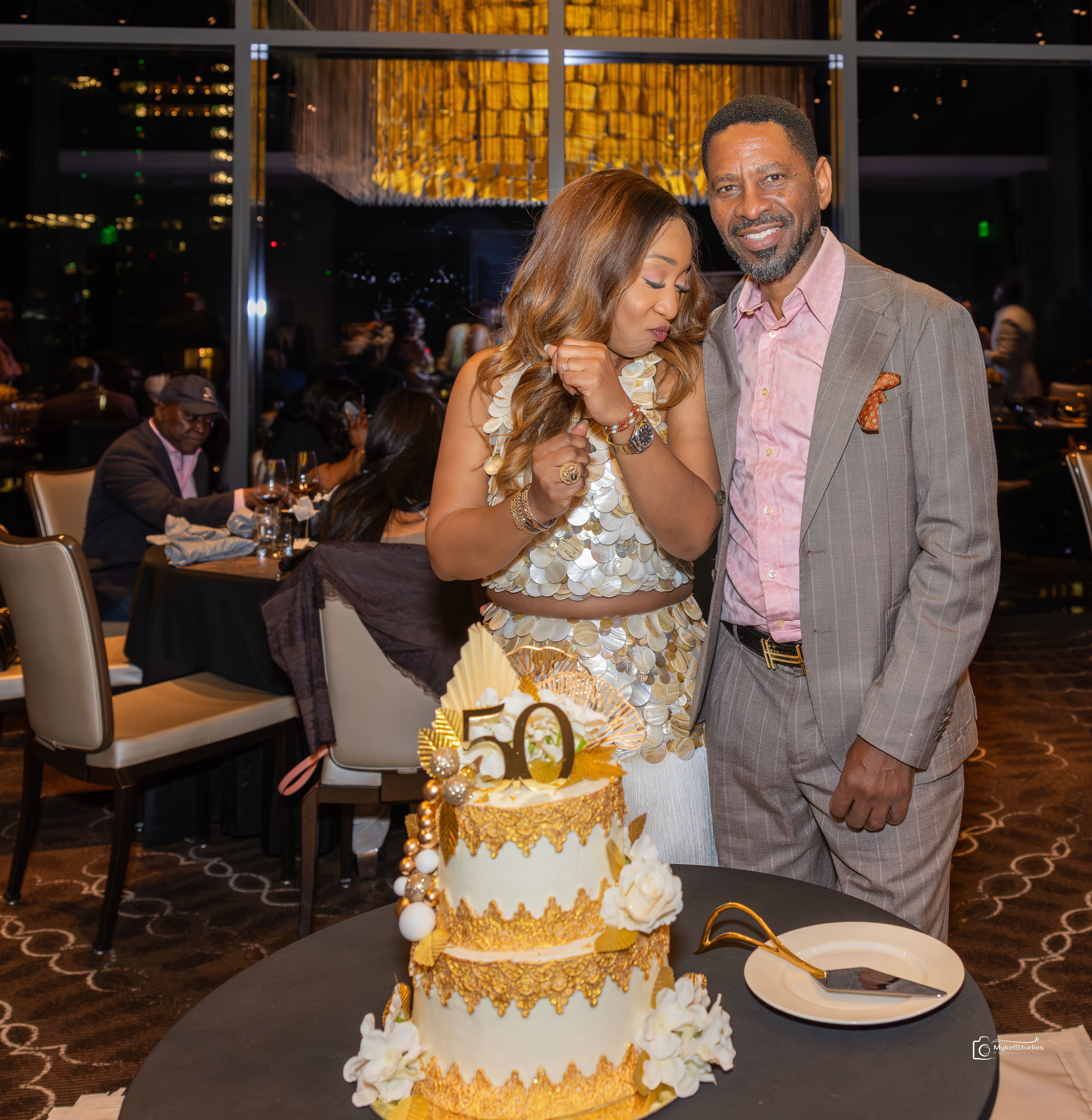 Man and woman over a birthday cake