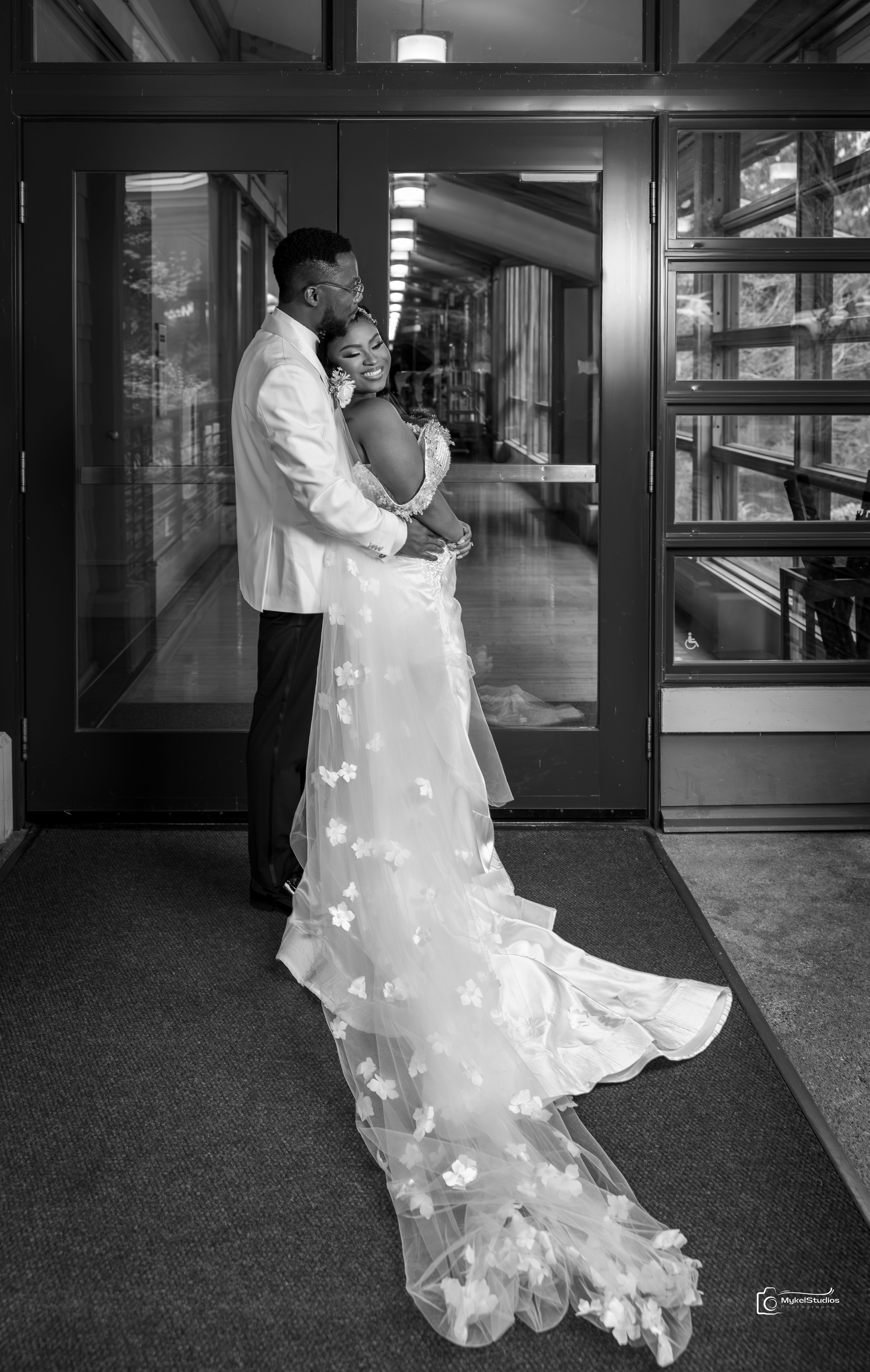 Bride and Groom standing infront of a door