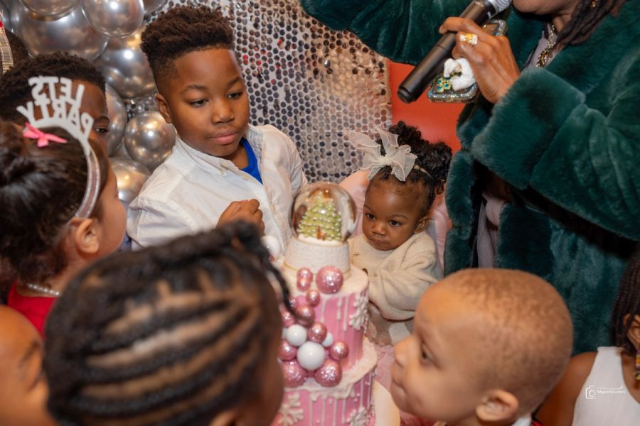 Kids surround a birthday cake 