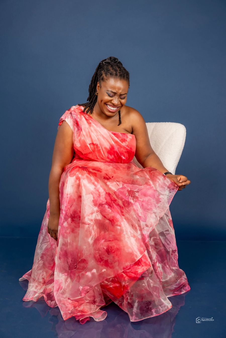 Lady in white chair smiling