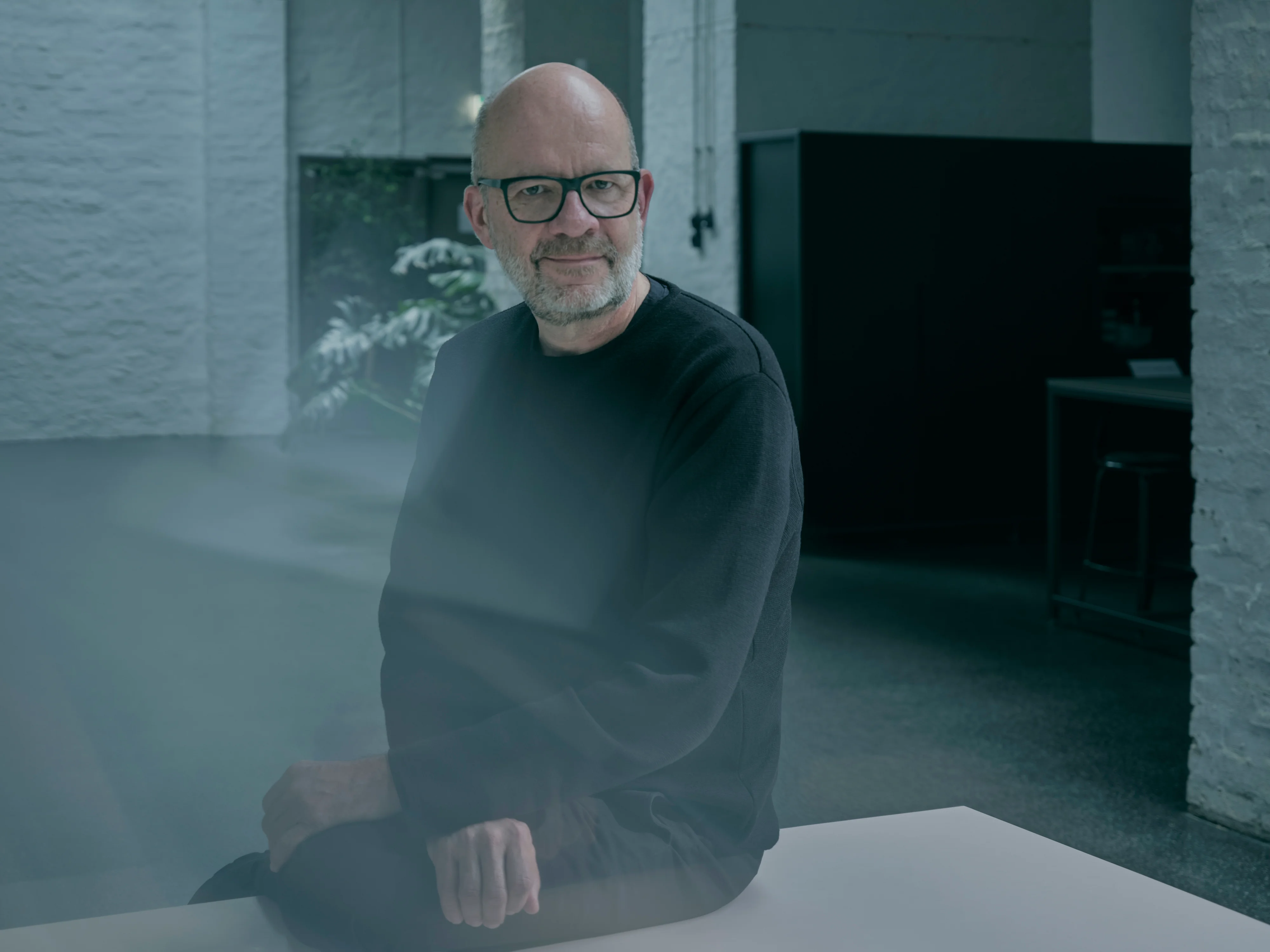 a group of people are standing next to each other on a red carpet cutting a red ribbon.