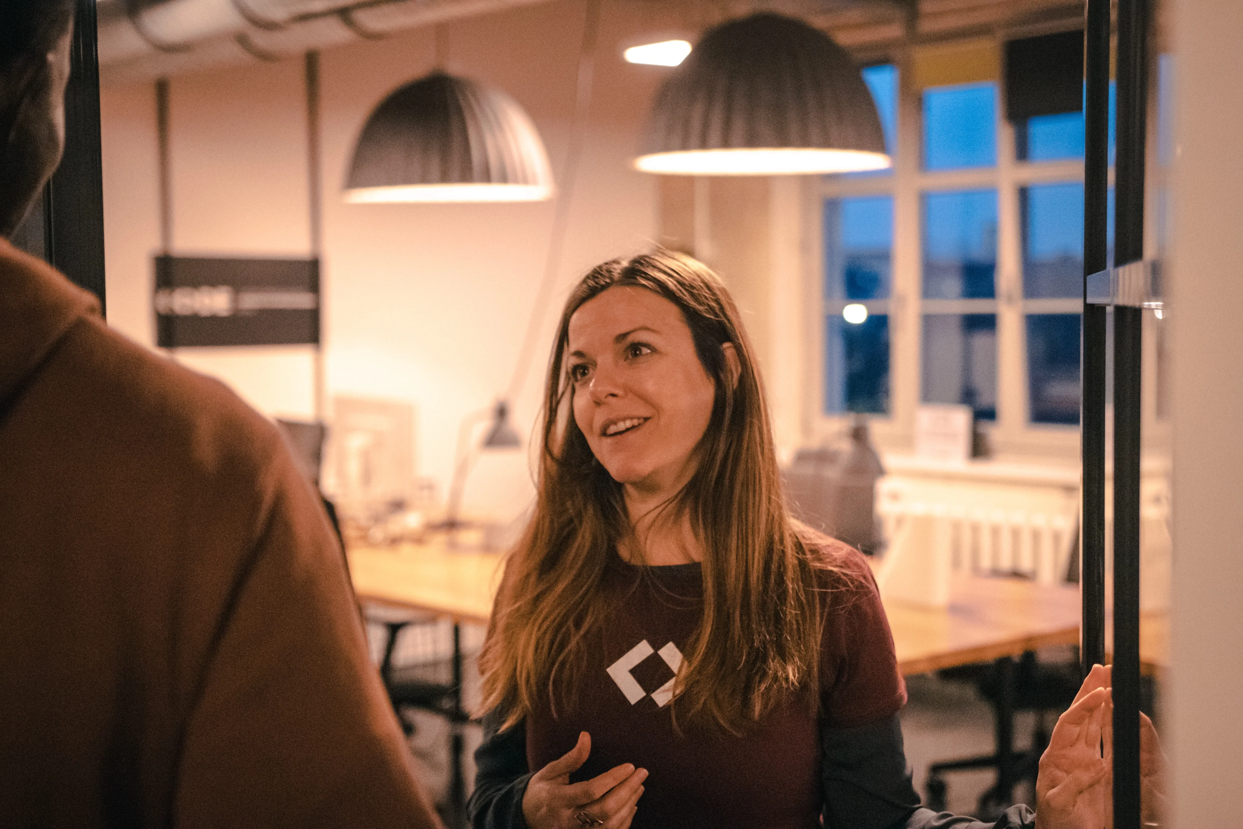 a woman is talking to a man in an office .