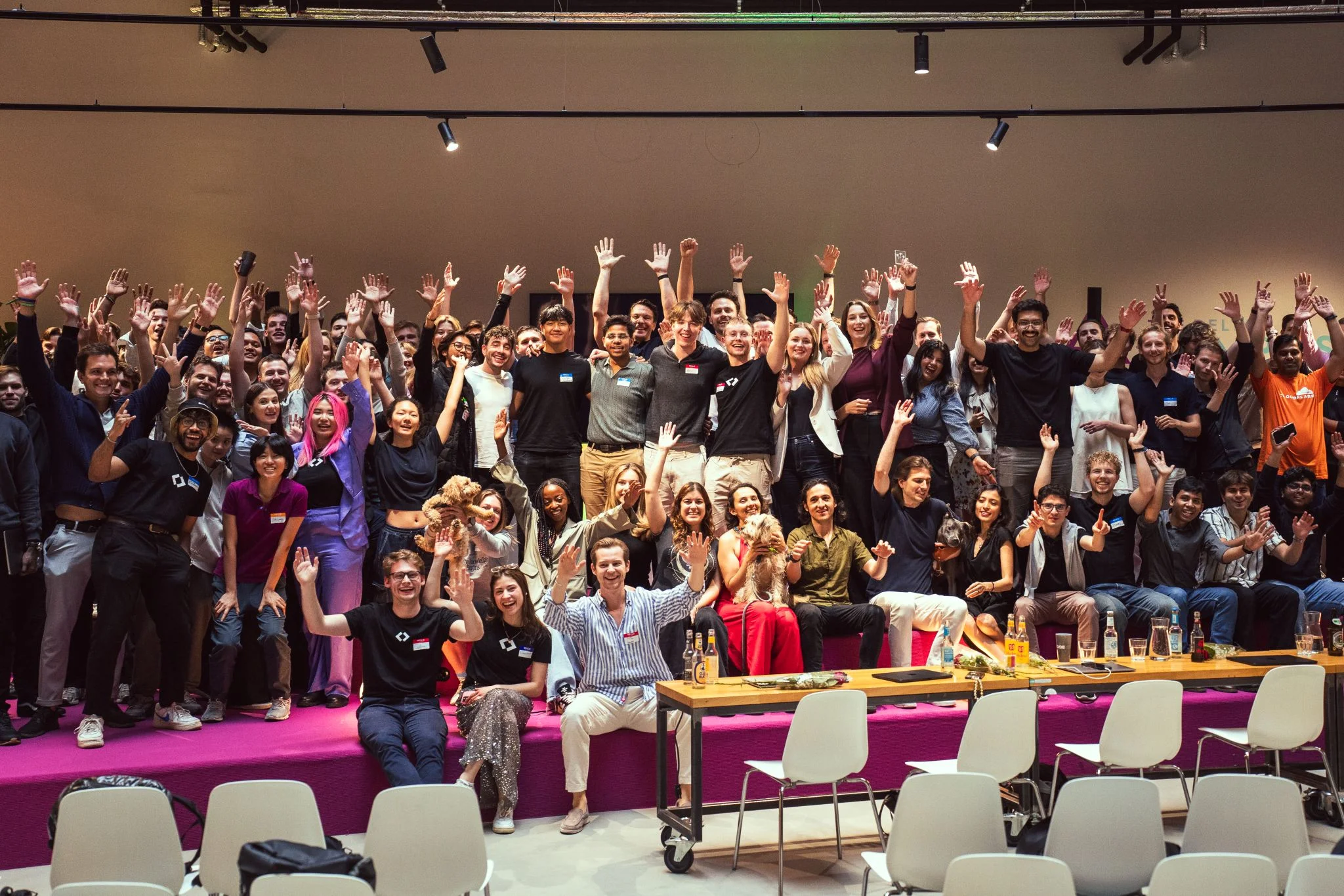 a group of hackathon participants and organizers on stage